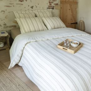 Housse de couette Olympe coton texturé et percale dans une chambre au style rustique avec mur en briques